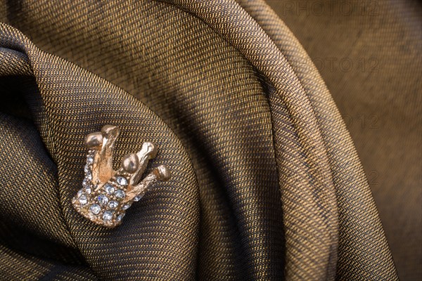 Little model crown placed on a linen canvas