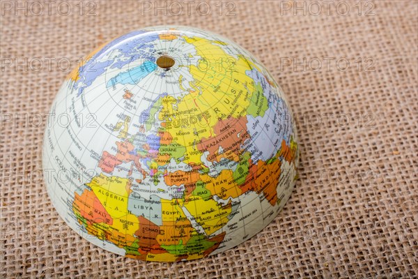 Globe placed on a brown fabric background