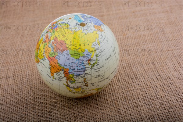 Globe placed on a brown fabric background