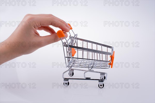 Hand holding a Cart on a white background