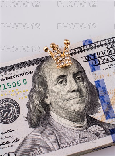 American 100 dollar banknotes and a gold color crown