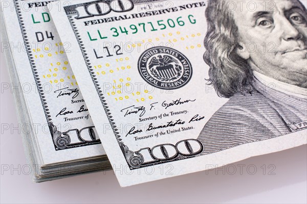 American 100 dollar banknotes made of paper placed on white background