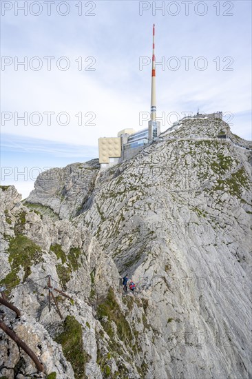 Climbers on a narrow ridge path