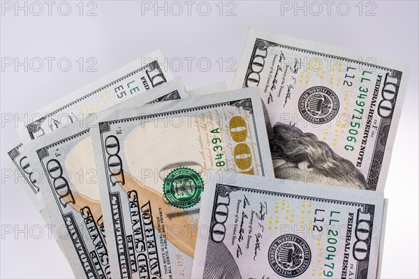American 100 dollar banknotes made of paper placed on white background