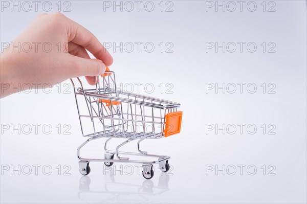 Hand holding a Cart on a white background
