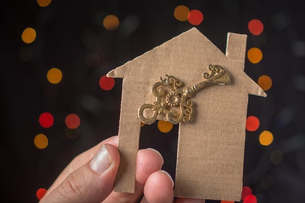 Key on paper house on a bokeh light background