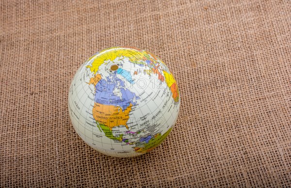 Globe placed on a brown fabric background