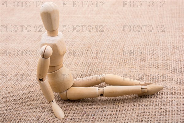 Wooden dolls of a man posing on canvas