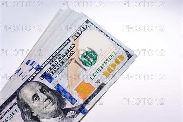 American 100 dollar banknotes made of paper placed on white background