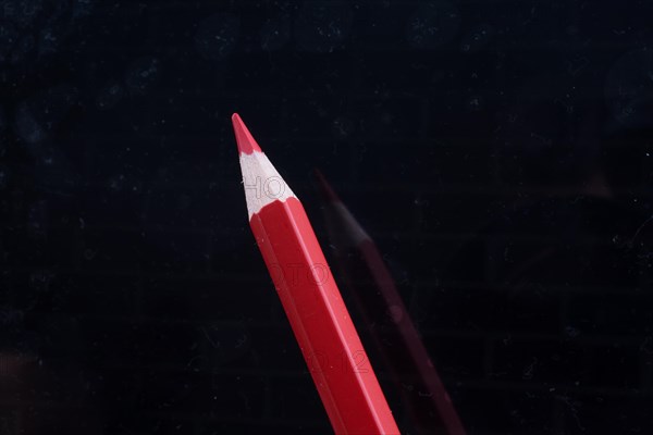 Red Pencil on a black background