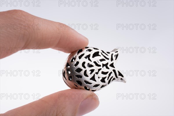Hand holding a tulip model on a white background
