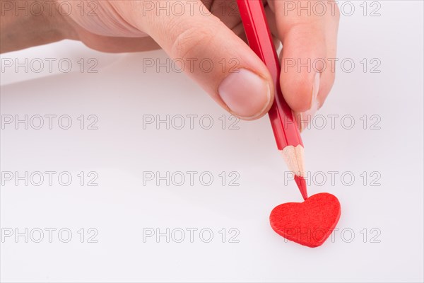 Pencil pointing a red heart