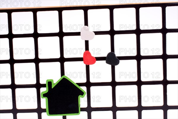 Green house on a grill with a few hearts
