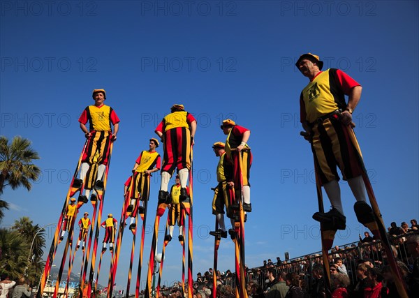 Stilt walkers in the street parade in Menton