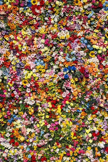 Artificial flowers on a house wall in Lisbon