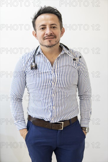 Portrait of latin doctor posing in his office