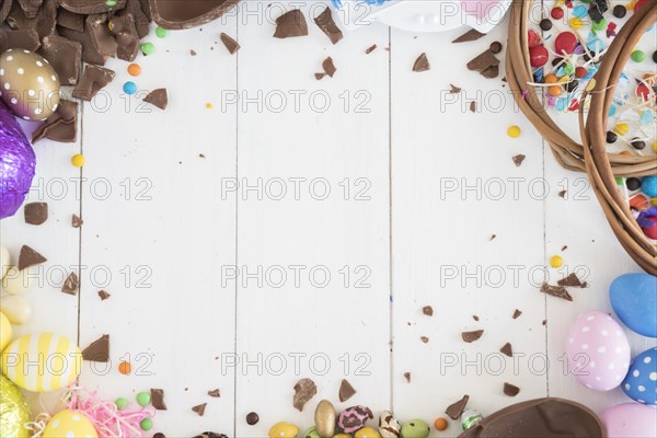 Easter chocolate eggs with candies wooden table