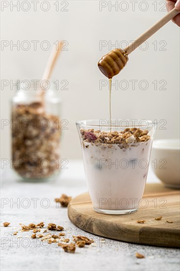 Front view yogurt with granola honey