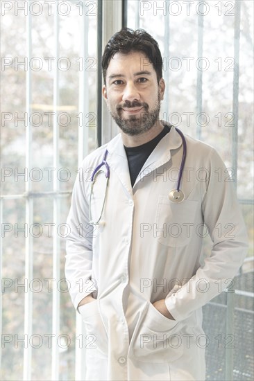 Portrait of latin doctor posing in his office