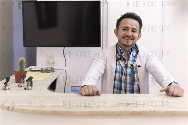 Latino doctor in the reception area of his clinic