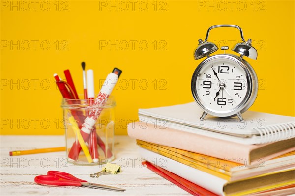 Back school concept clock pile books