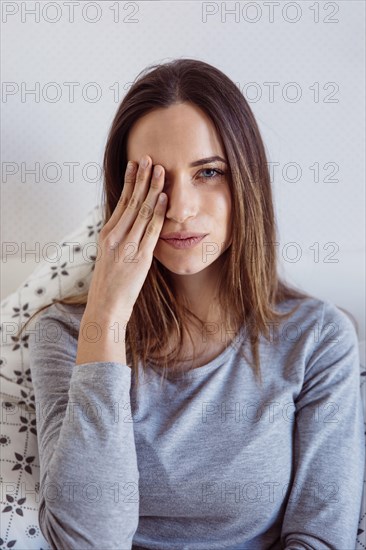 Pretty woman covering eye