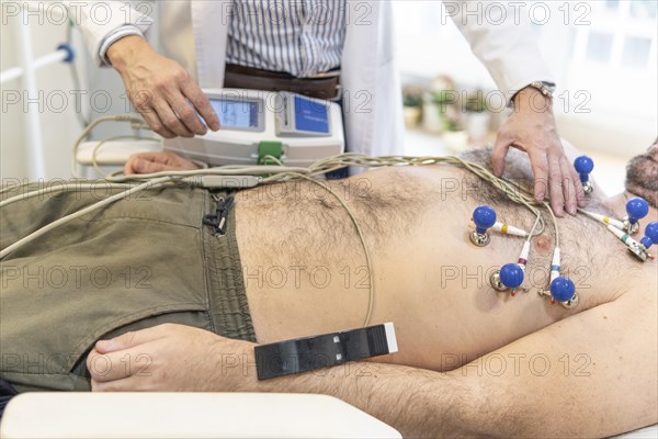 Doctor performing electrocardiogram. Heart exam