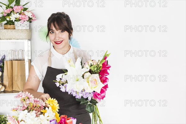 Portrait happy woman with bunch flowers