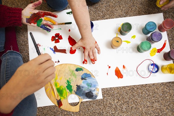 High angle child woman painting