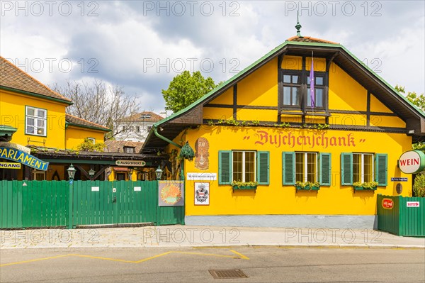 Buschenschank with yellow facade and green shutters