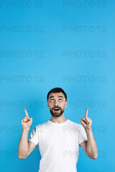 Man posing pointing up