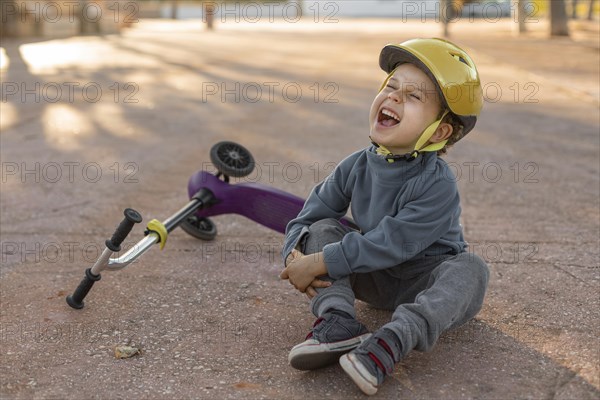 Little boy outdoors hurt from feel scooter