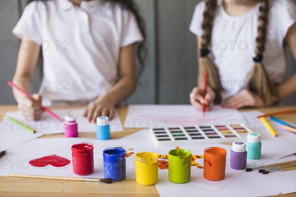 Colorful paint colors front girl painting white paper table