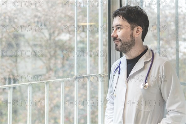 Portrait of latin doctor posing in his office