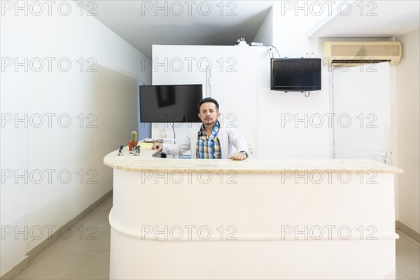 Latino doctor in the reception area of his clinic
