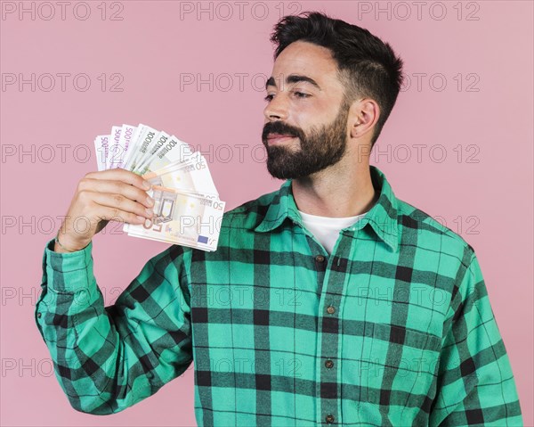 Medium shot guy holding money