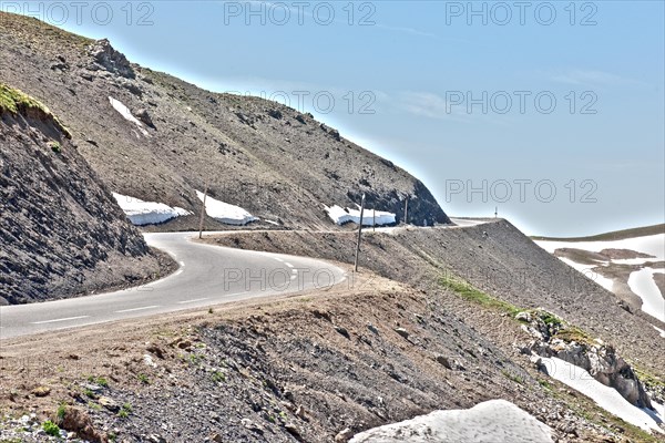 Photo with reduced dynamic saturation HDR of mountain pass alpine mountain road alpine road pass road pass view of highest asphalted alpine road ring road around Cime de la Bonette next to Col de la B...