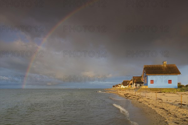 Rainbow and beach houses on the peninsula Graswarder