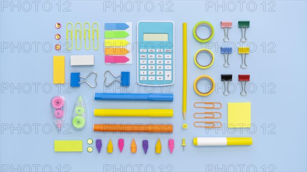 Top view colorful office stationery with calculator paper clips
