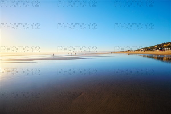 Atlantic ocean sunset with surging waves at Fonte da Telha beach