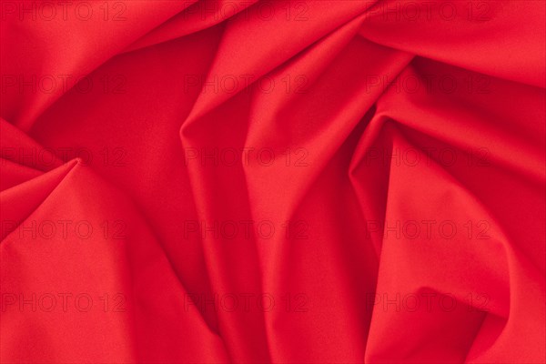 Folded red textile fabric texture background
