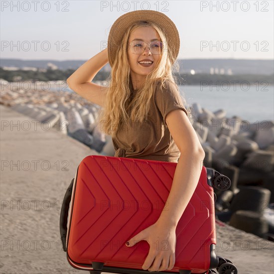 Medium shot happy woman with luggage