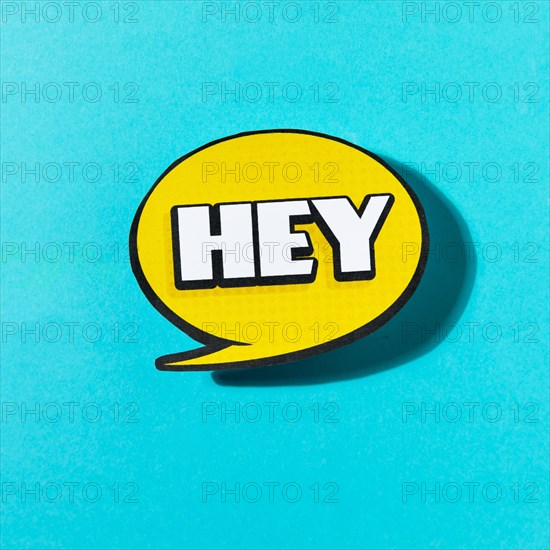 Hey text yellow speech bubble blue background
