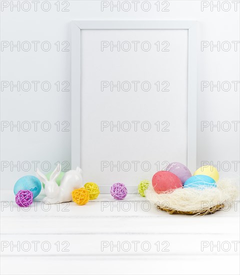 Easter eggs nest with blank frame table