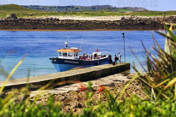 Tourist group on tour boat at jetty