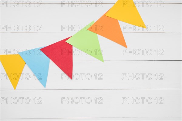 Colorful triangular bunting white wooden plank