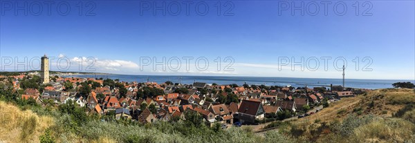 Panorama of the small town of West on Terschelling with the landmark Brandaris and view of the Wadden Sea