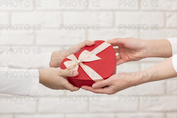 Close up boy offering chocolate box mother