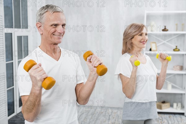 Joyful couple exercising home