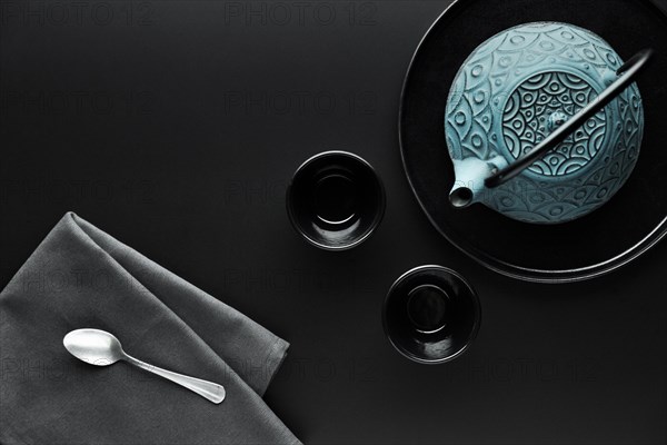 Flat lay crockery with teapot silver spoon